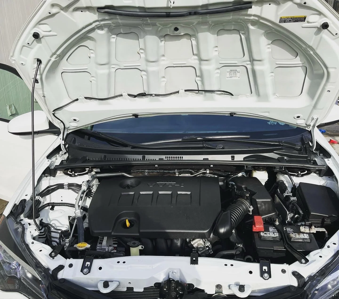 Toyota Corolla engine bay after professional engine cleaning by BryanzAutoDetailing.