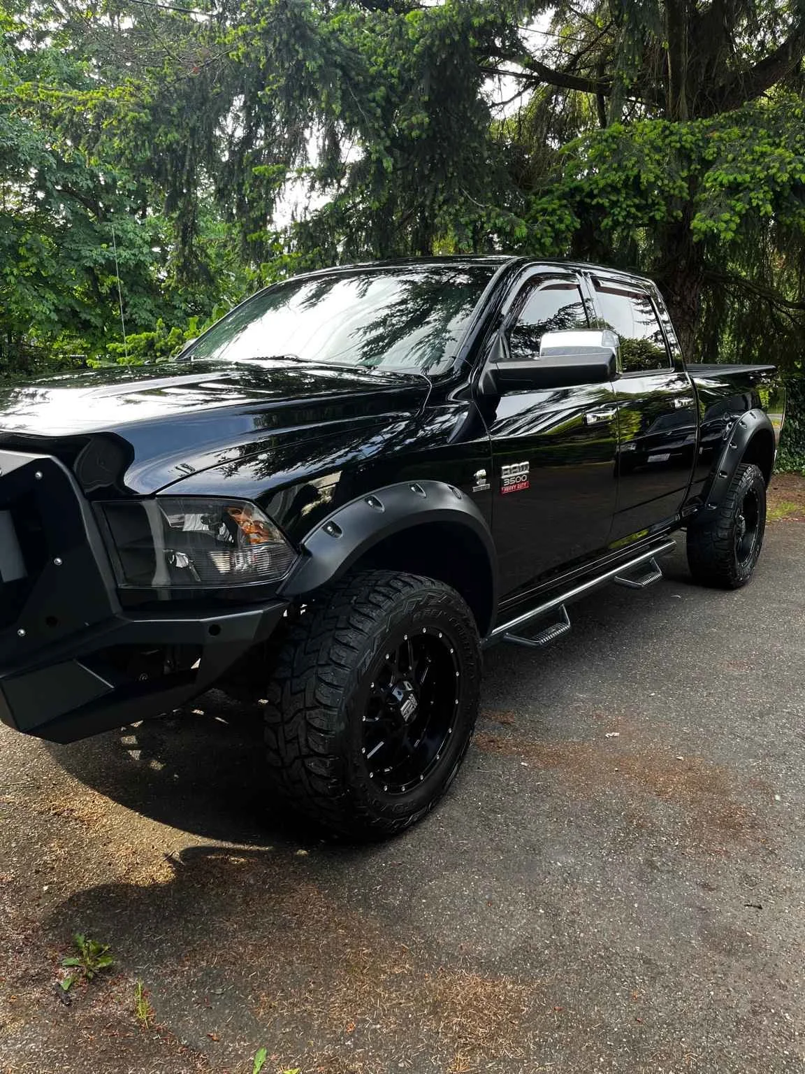 Black Dodge RAM 3500 after professional paint correction by Bryanz Auto Detailing in Washington showing high-gloss reflection and flawless finish.