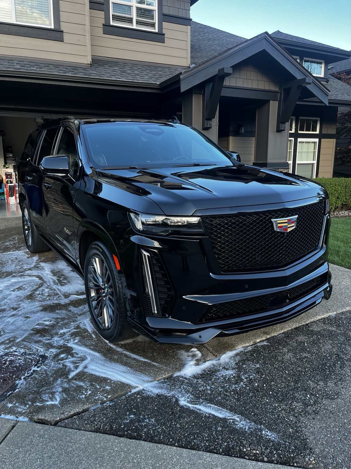 Glossy black Cadillac Escalade exterior after professional detailing by Bryanz Auto Detailing
