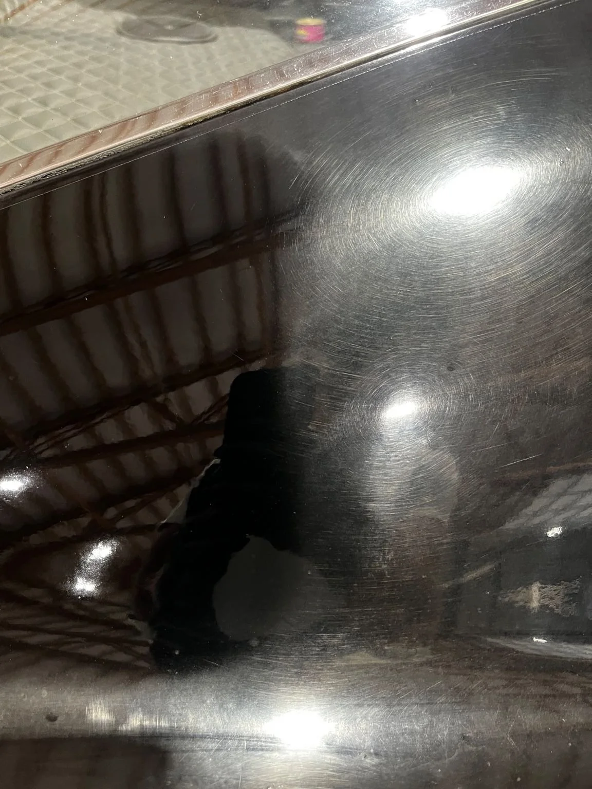 Black paint panel showing swirl marks and oxidation before paint correction by Bryanz Auto Detailing in Washington.