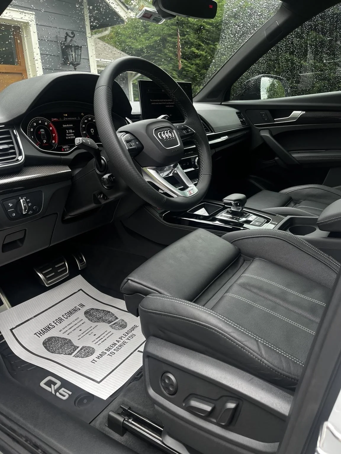 Audi Q5 black leather front interior after professional interior detailing in Maple Vallery, WA by Bryanz Auto Detailing