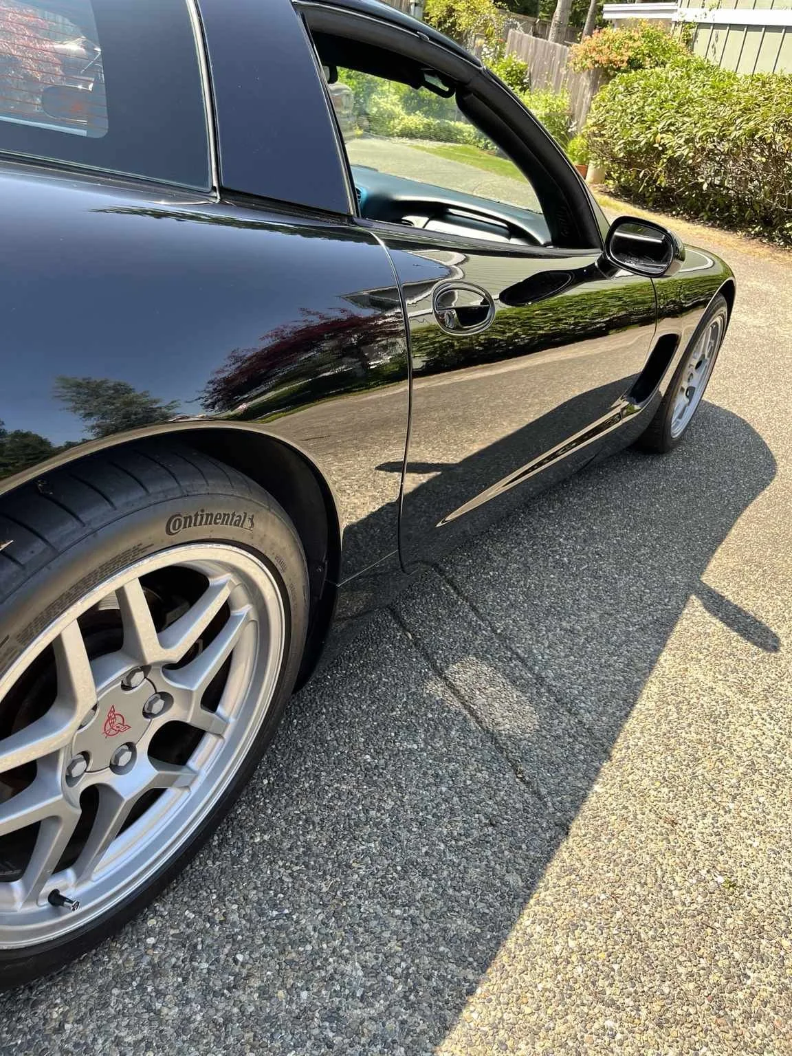 Black Corvette with glossy paint after professional paint correction