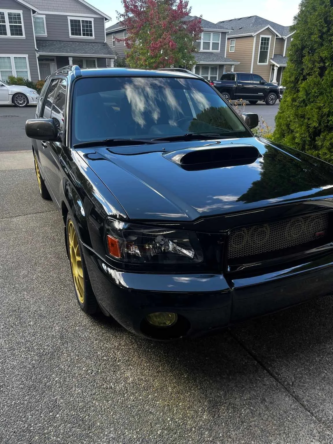 Black Subaru Forester after full paint correction and polishing by Bryanz Auto Detailing in Washington, showcasing deep gloss and reflection.