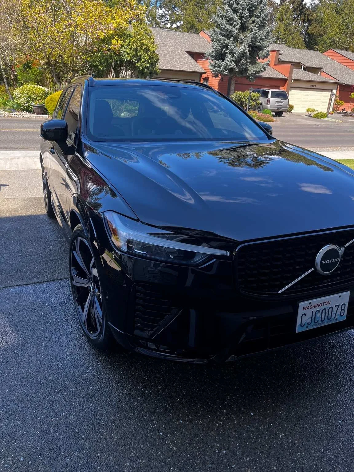 BryanzAutoDetailing performing a premium wash and wax on a black Volvo XC60 with a high-gloss finish.