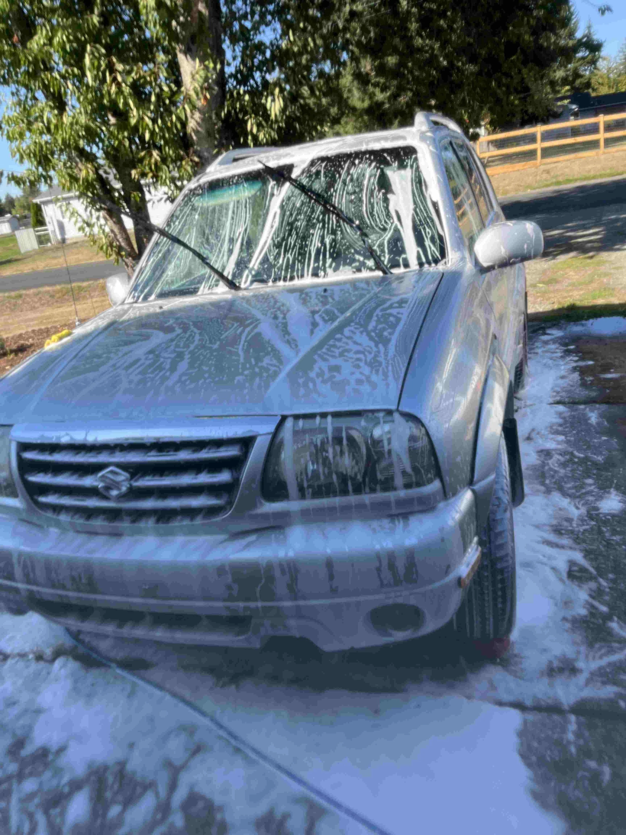 SUV covered in foam during professional car wash and detailing in University Place, Washington by Bryanz Auto Detailing