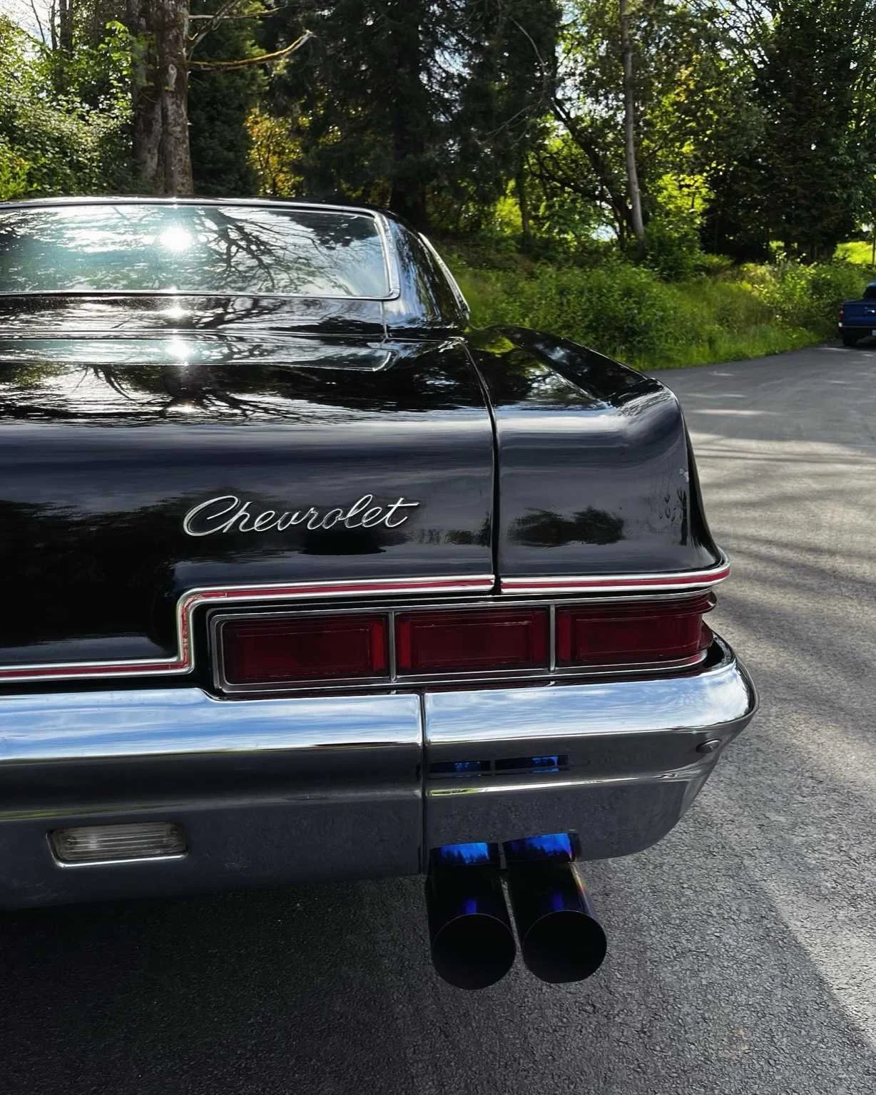 Classic black Chevrolet after full paint correction and polishing by Bryanz Auto Detailing in Washington, showing mirror reflection and deep gloss.