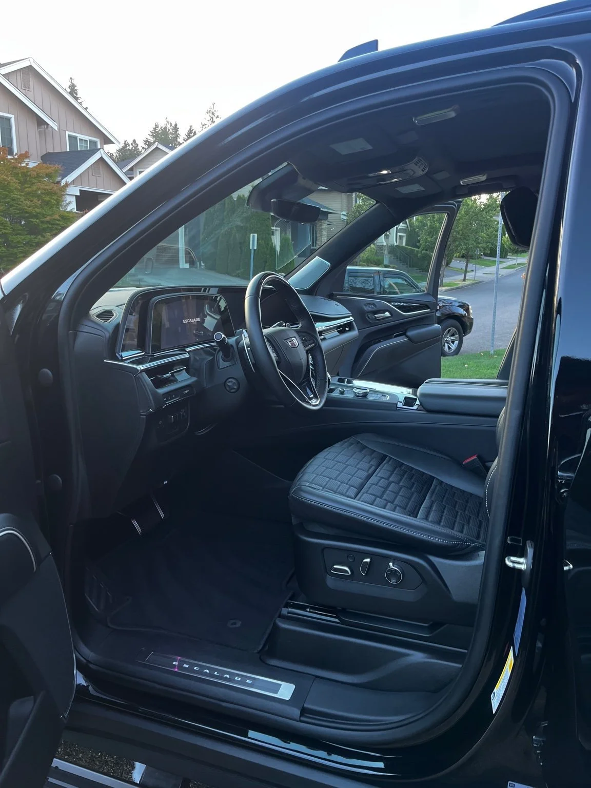Clean Cadillac Escalade interior after mini interior detail - vacuumed carpets, wiped surfaces, leather cleaned and protected by Bryanz Auto Detailing.