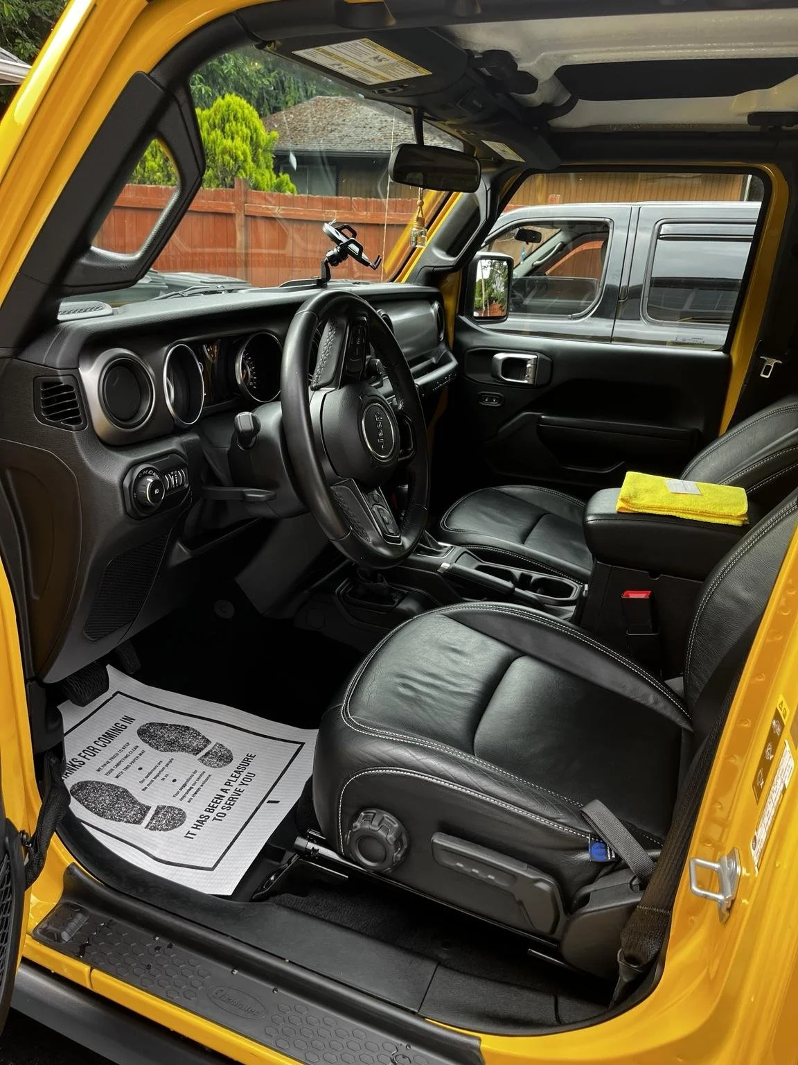 Profesional Jeep Wrangler interior detailing completed by Bryanz Auto detailing for a Covington, WA Customer with deep cleaned leather seats, dashboard, and interior surfaces