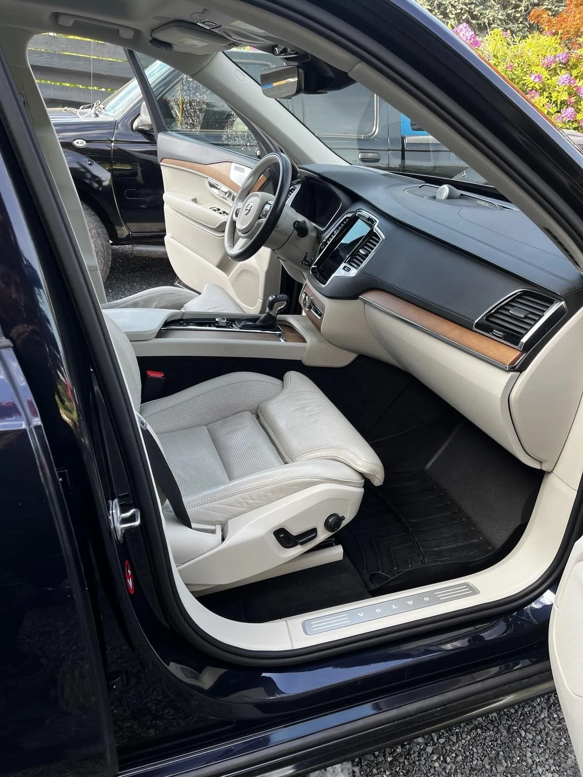 Professional interior car detailing service in Maple Valley WA deep cleaning a Volvo interior with clean leather seats and detailed dashboard
