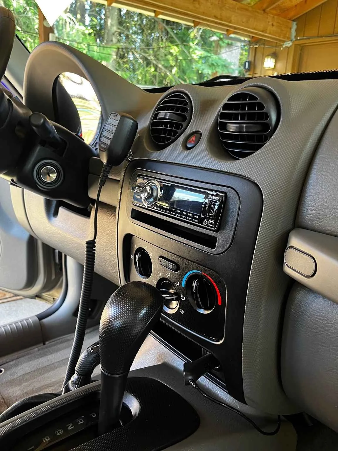 Jeep Liberty interior detailing with deep cleaned center console, restored dashboard, and refreshed cabin surfaces.