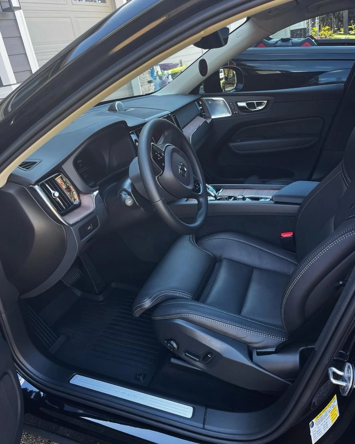 Clean Volvo interior featuring black leather seats, dashboard, and floor mats after professional detailing by Bryanz Auto Detailing.