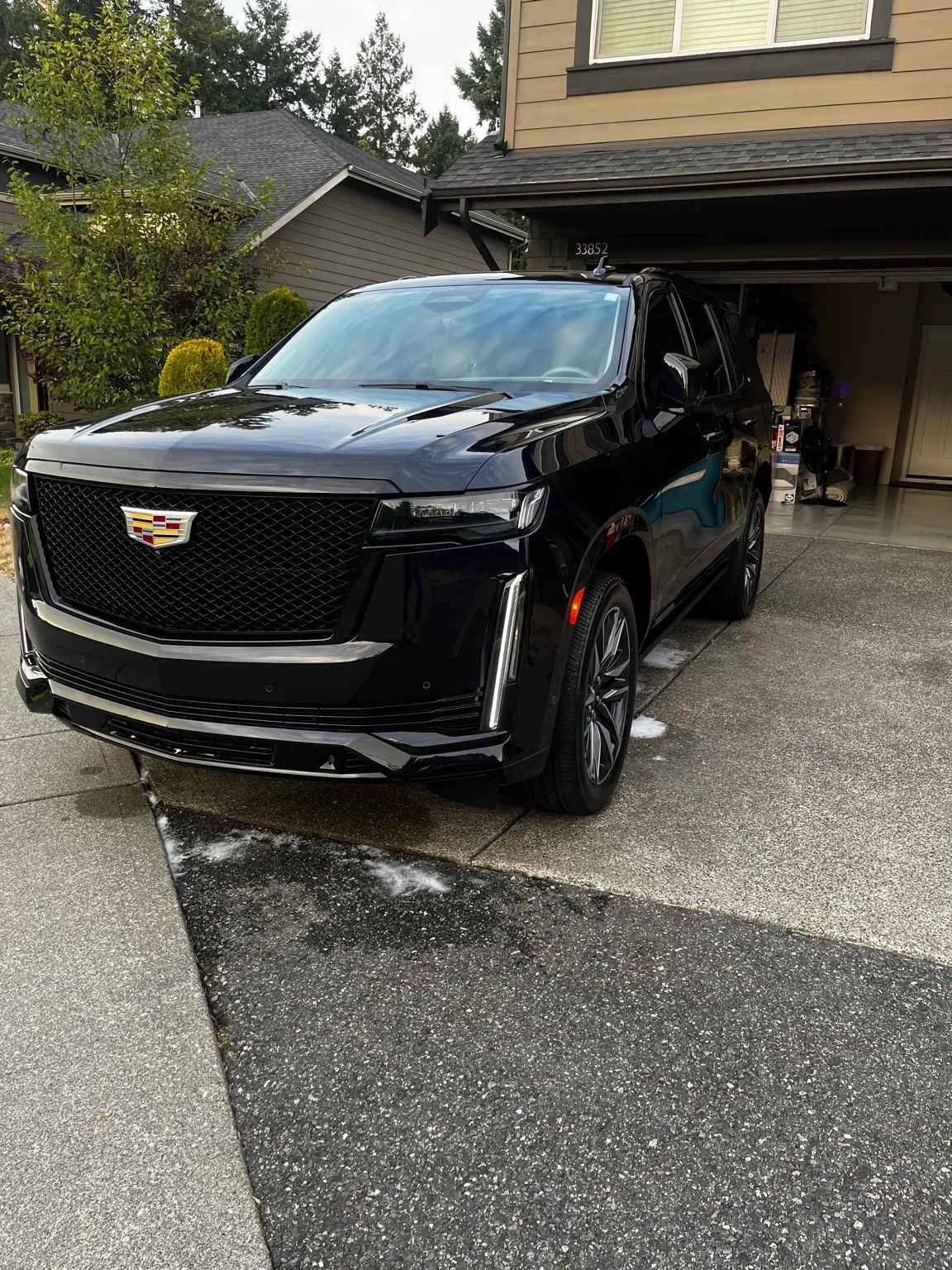 Cadillac Escalade after professional mobile detailing in Graham, WA with high-gloss black paint finish.