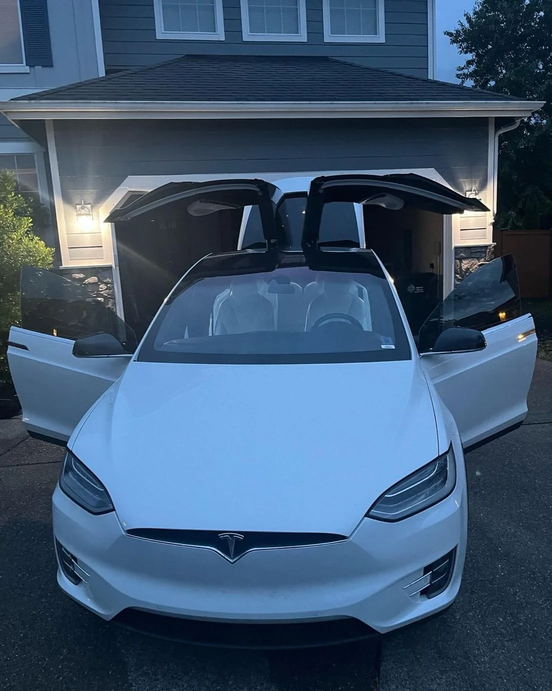 Fife Tesla Model X detailing with falcon wing doors open and spotless white exterior
