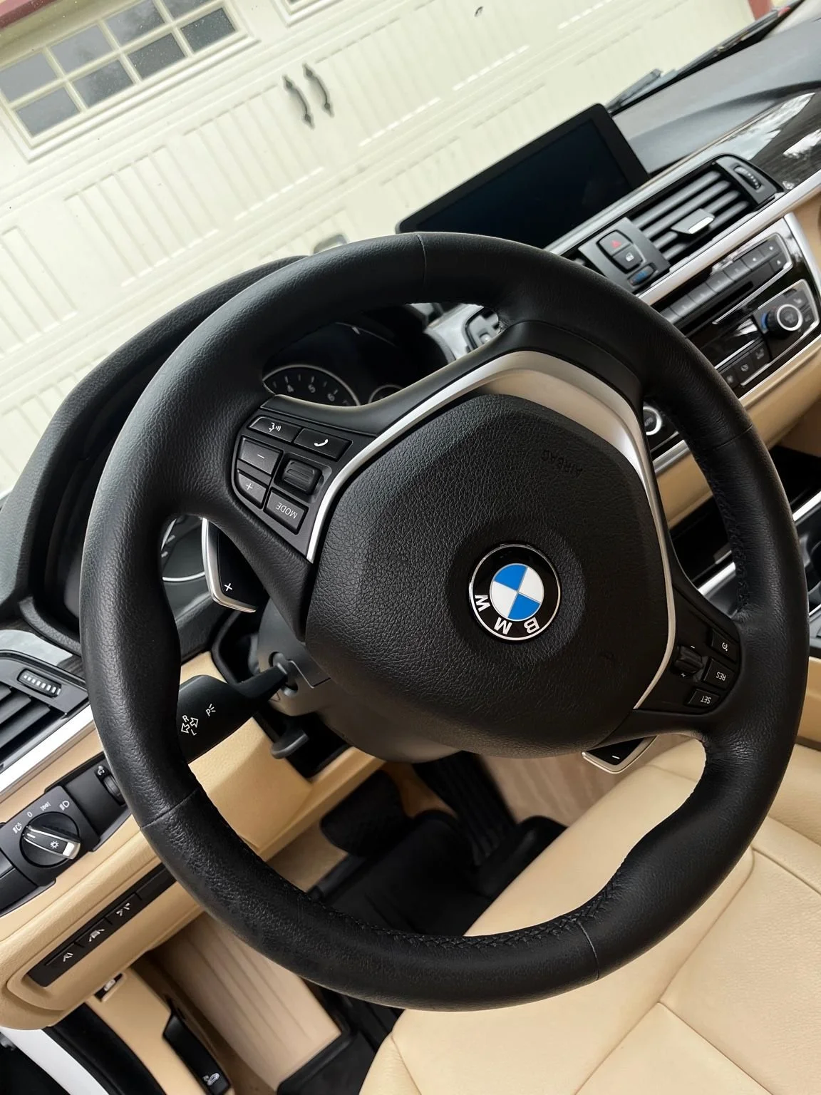 BMW interior detailing in Graham, WA with deep cleaning of leather steering wheel and tan interior.