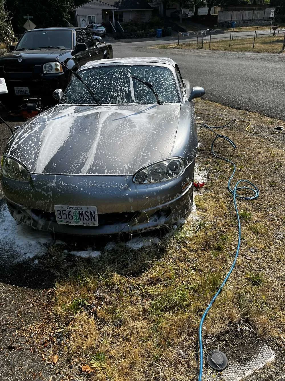 Silver Mazda Miata receiving a thick foam wash during mobile detailing service by Bryanz Auto Detailing in Tacoma, WA