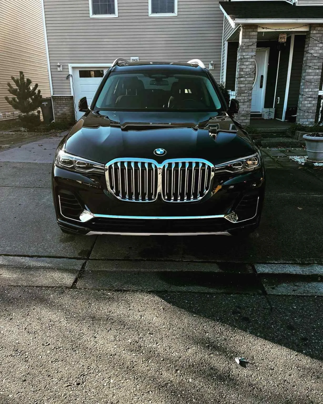Black BMW SUV after professional paint correction by Bryanz Auto Detailing in Washington, showing deep mirror reflection and luxury finish.