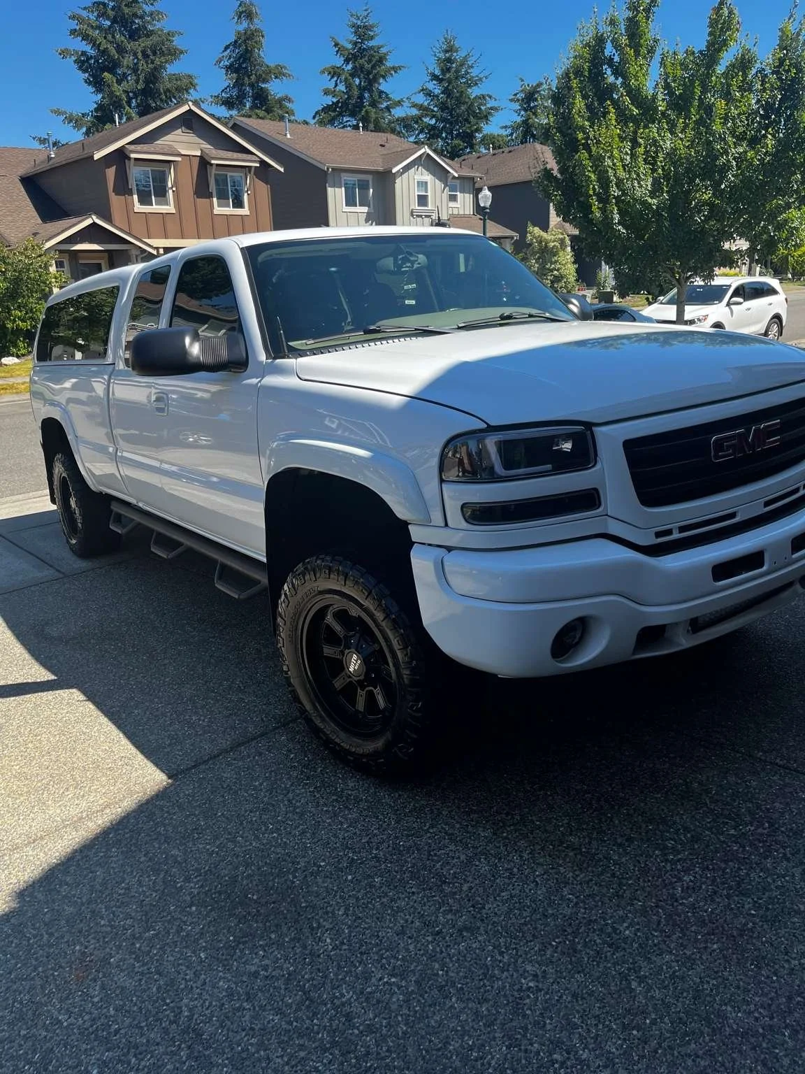 White GMC truck after full paint correction and polishing by Bryanz Auto Detailing in Washington, showcasing swirl-free reflections and a deep gloss finish.