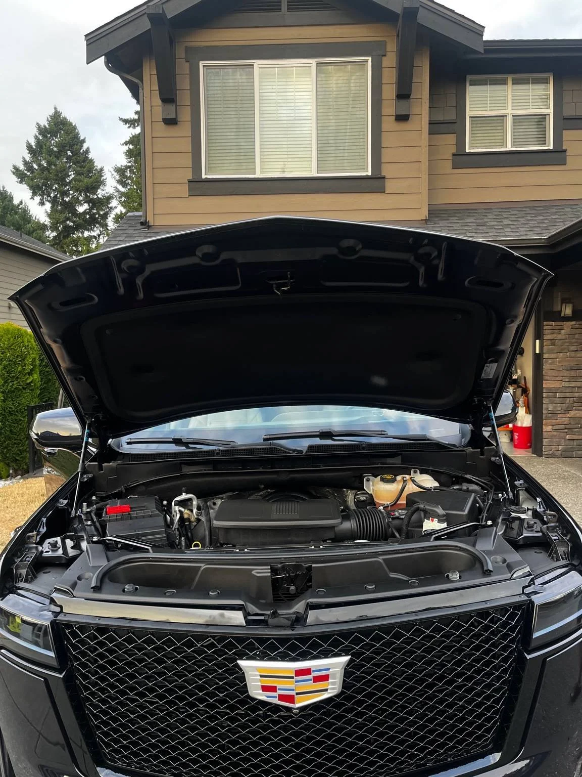 Clean Cadillac engine bay after professional engine detailing by BryanzAutoDetailing showing a safely degreased and dressed engine compartment.