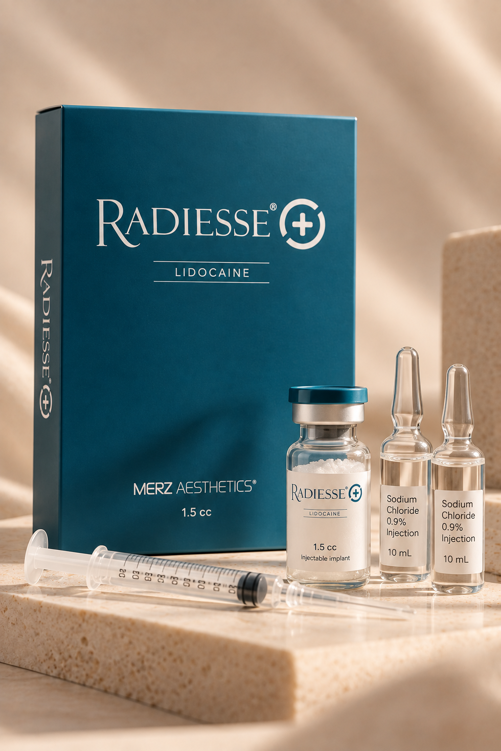 Box of Radiesse Lidocaine, a syringe, and small vials labeled sodium chloride injections, placed on a beige surface in a medical setting.