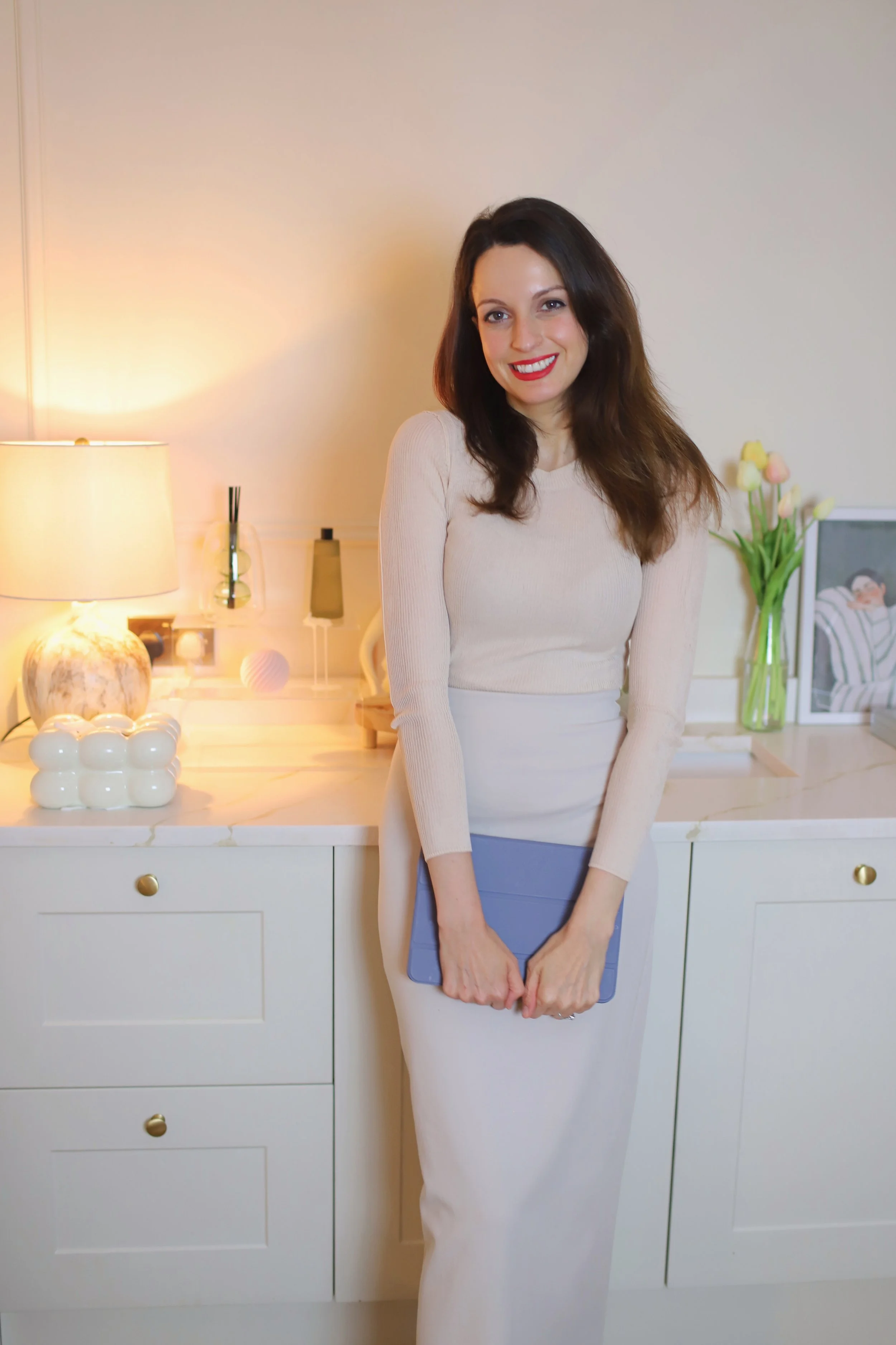 Dr Caroline Warden sat on a treatment bed at her aesthetic clinic in Hale that offers a premium service for botox, fillers, microneedling, chemical peels, skin boosters, profhilo, obagi medical grade skin care and more