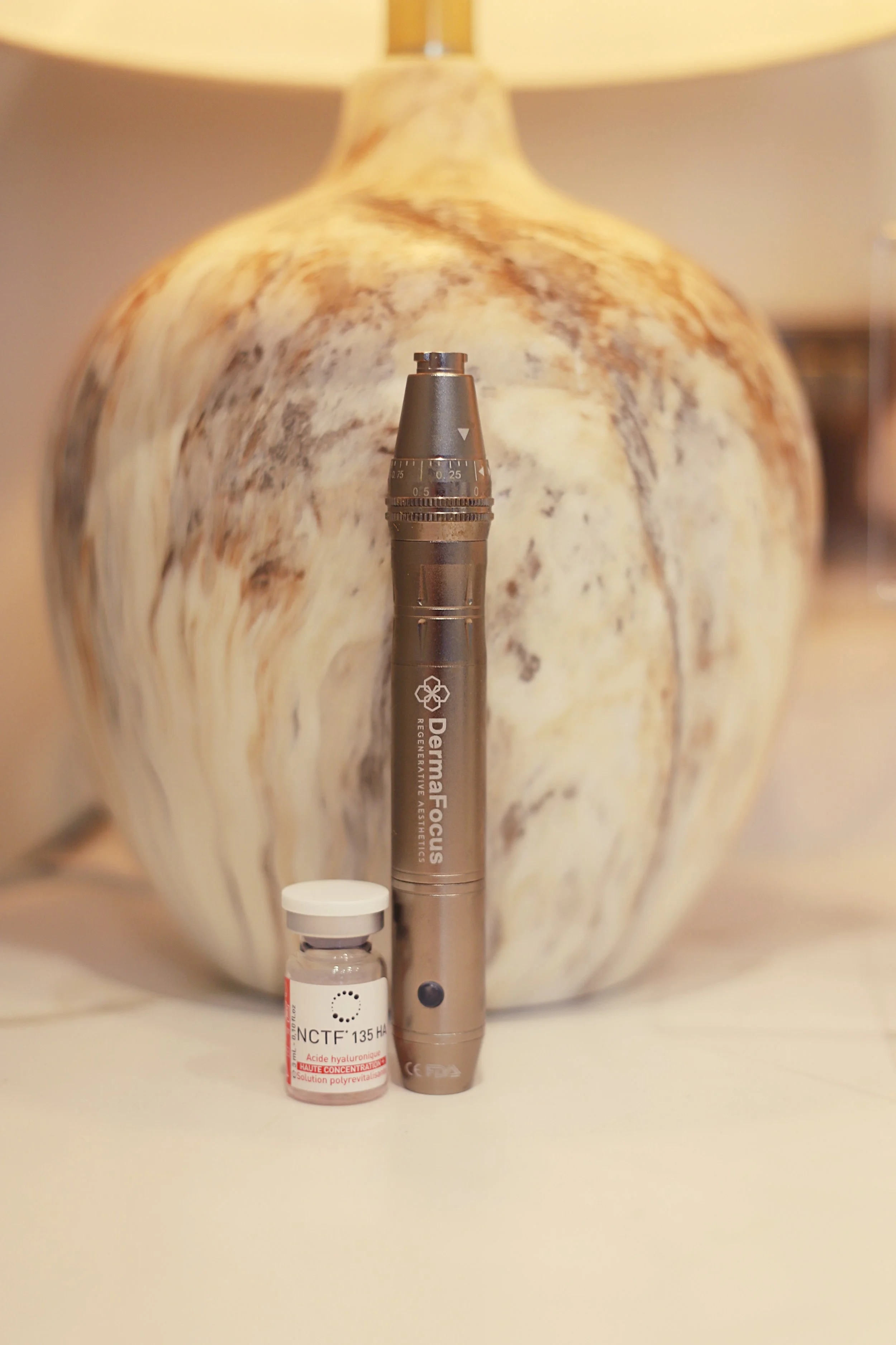 Premium image of a Dermafocus microneedling pen alongside a skin treatment kit