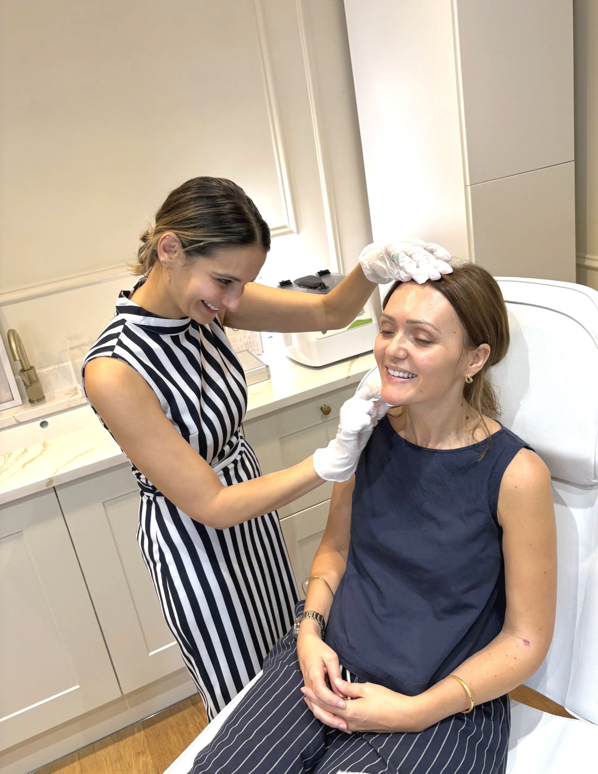 Dr Caroline Warden with a patient in the treatment room at her Hale aesthetic clinic