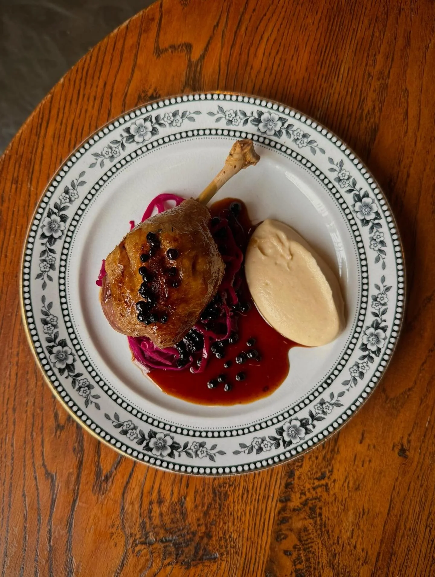 Confit duck leg, pickled red cabbage, celeriac pur&eacute;e, elderberries.