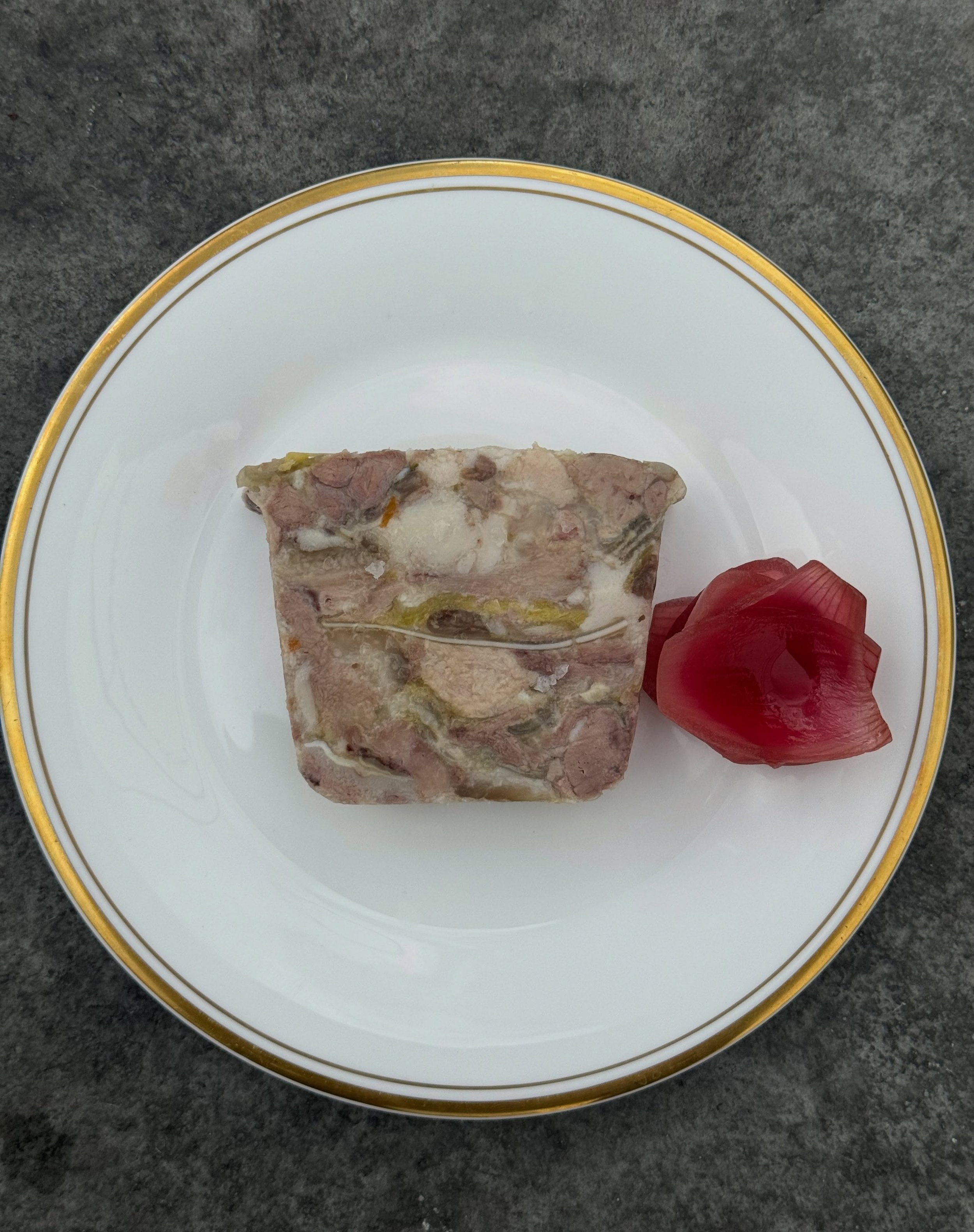 Pig&rsquo;s head terrine, pickled red onions &amp; toast.
An often, and unfairly, overlooked part of the pig. Braised gently for a few hours with a plethora of herbs and vegetables until the meat becomes tender and falls off the bone. The rich stock 