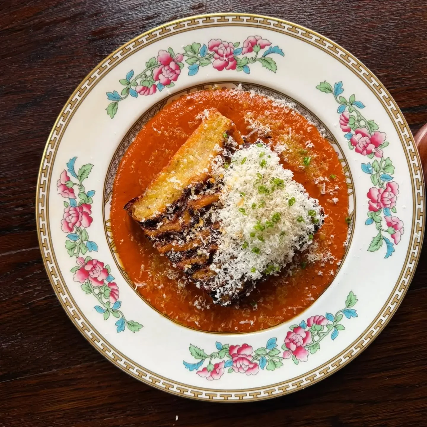 It's just a lasagna, nice and simple.

12-hour braised beef in a classic rich ragu, handmade pasta, parmesan-laden bechamel. Cooled and compressed, sliced and baked for all the crispy edges. Served with a vodka tomato sauce and a lot more parmesan.

