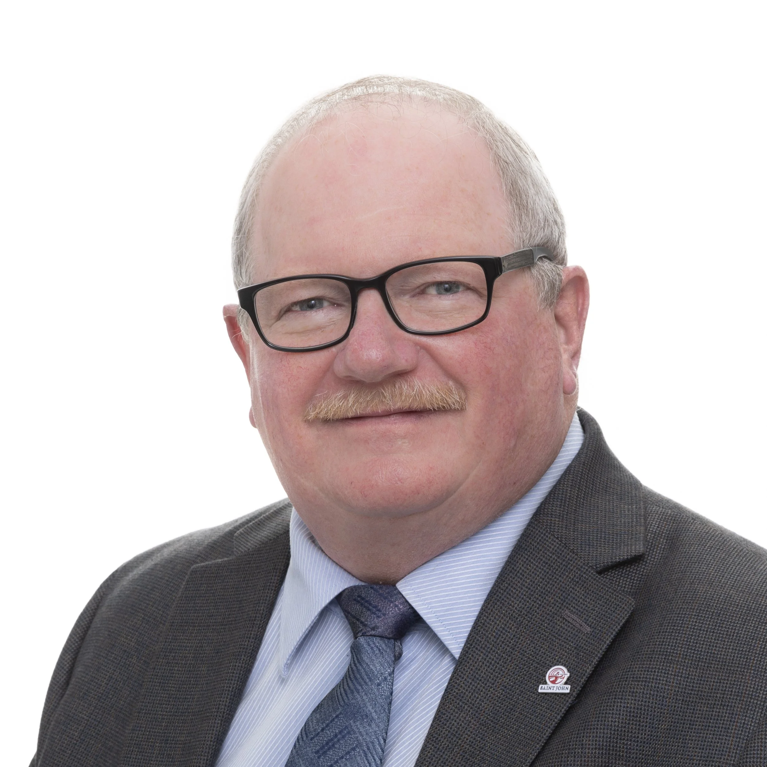 Portrait of a middle-aged man with glasses, a mustache, wearing a suit and tie, against a white background.