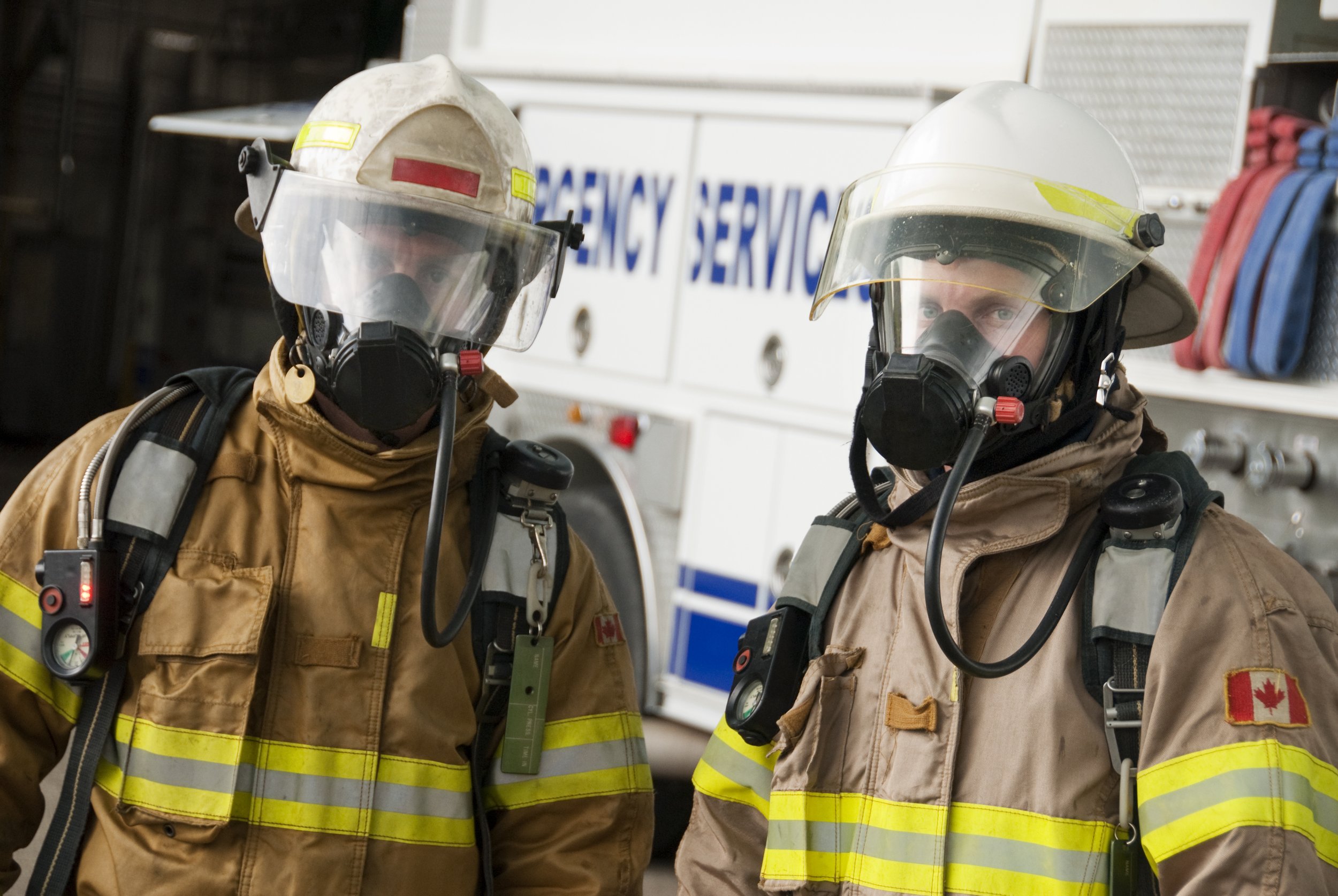 Emergency services, two firefighters wearing masks