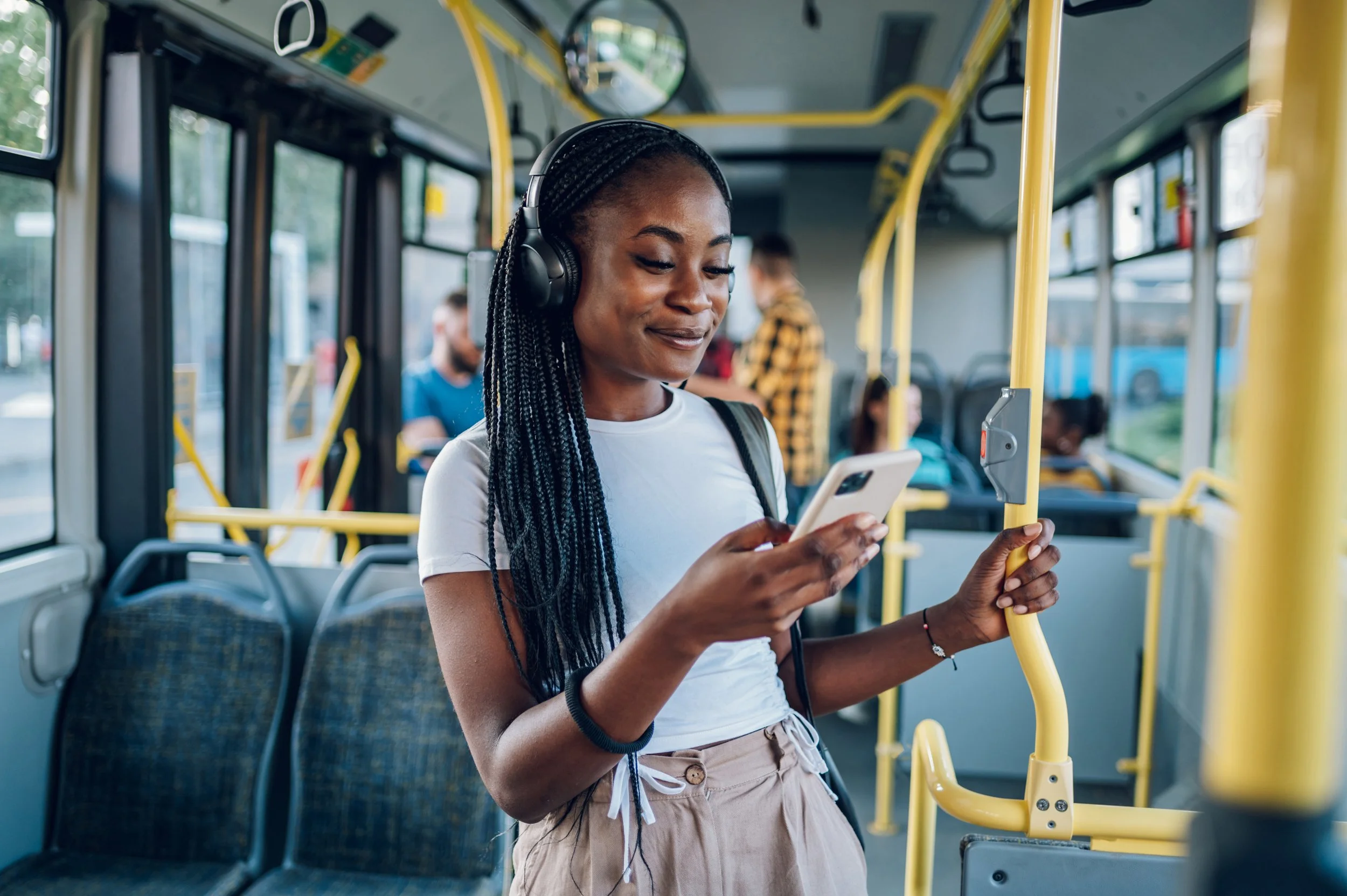 Person on their phone on public transport bus