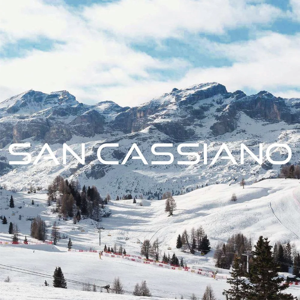 Skiers exploring snowy slopes in the Dolomites mountain range