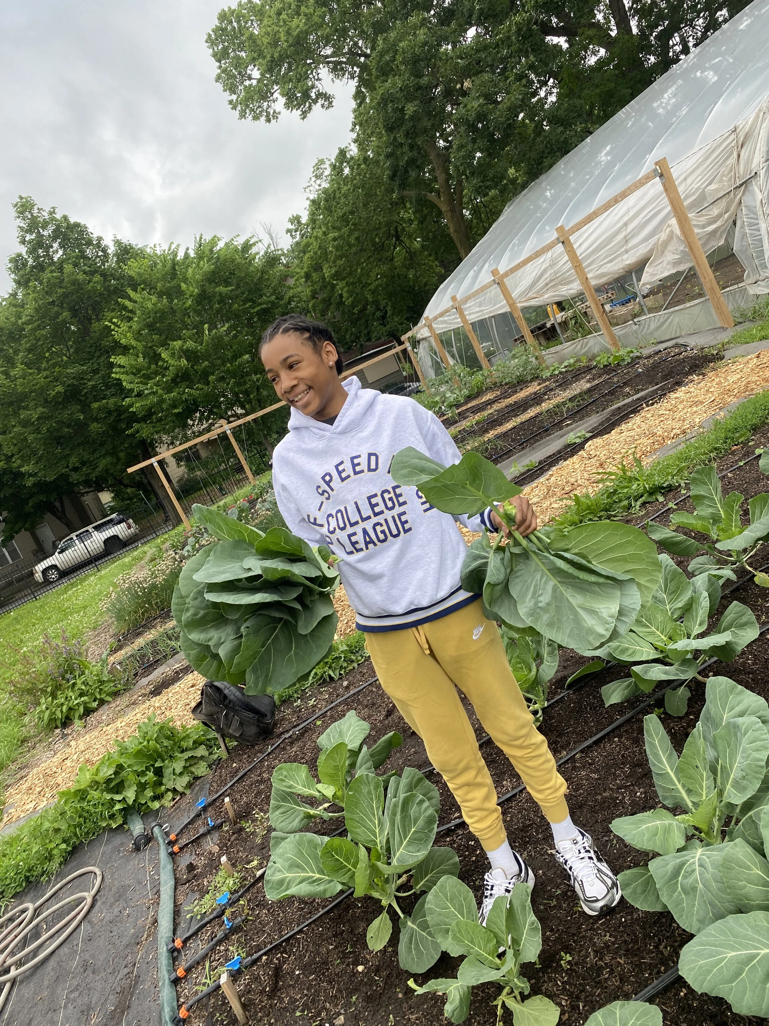 Heman holding collards.jpeg