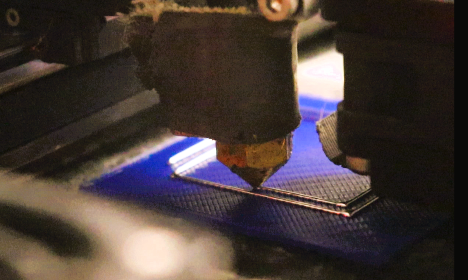 FDM 3D printer printing conductive electronic traces in a square pattern with cu29 conductive filament.