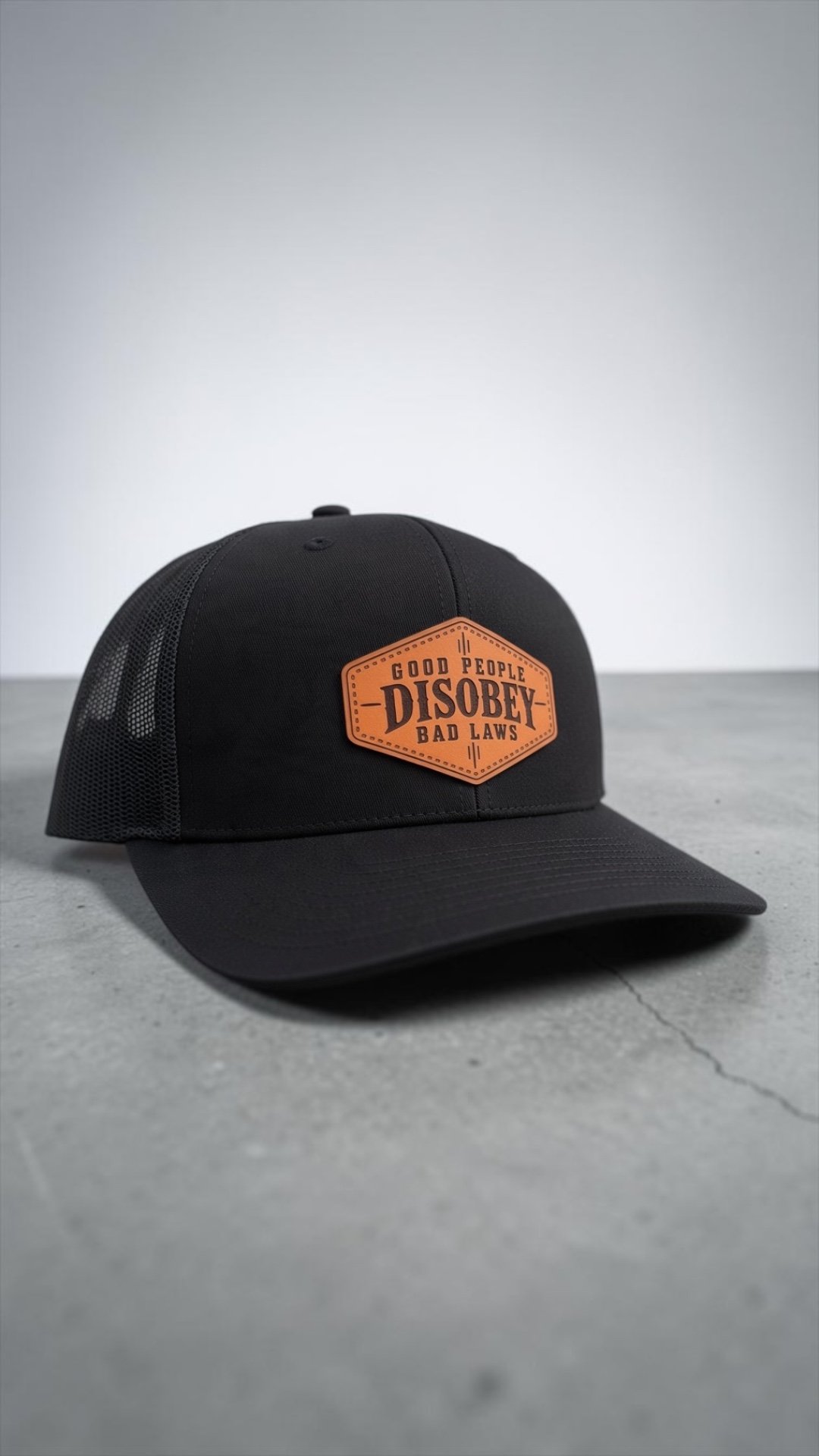 Front view of black Richardson 112 snapback featuring a laser-engraved genuine leather patch.
