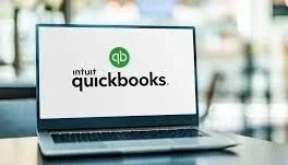 Laptop displaying the QuickBooks logo on its screen