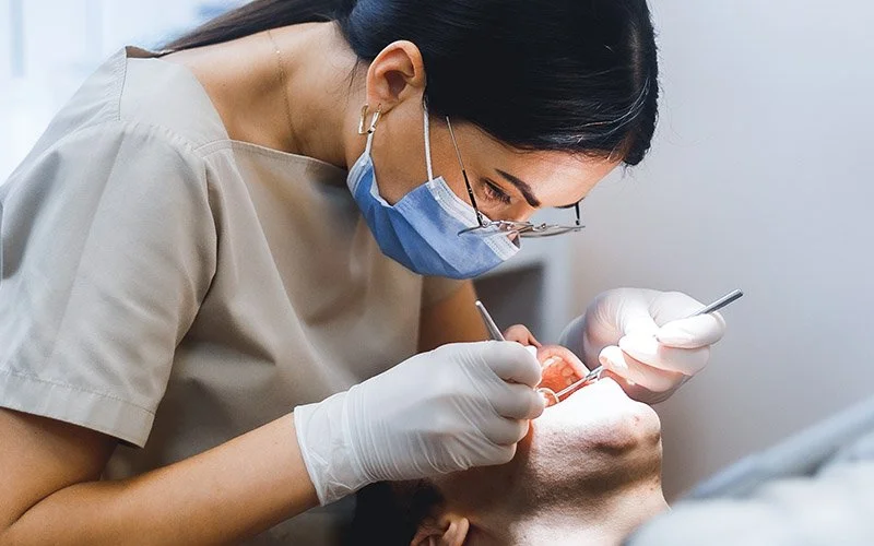 Dentist or hygienist working on a patient