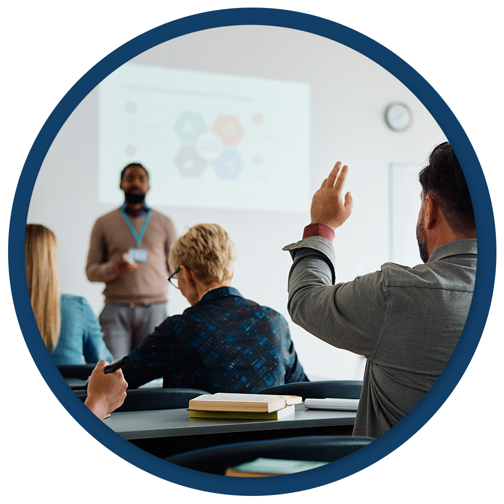 Student is raising his hand in a college classroom.