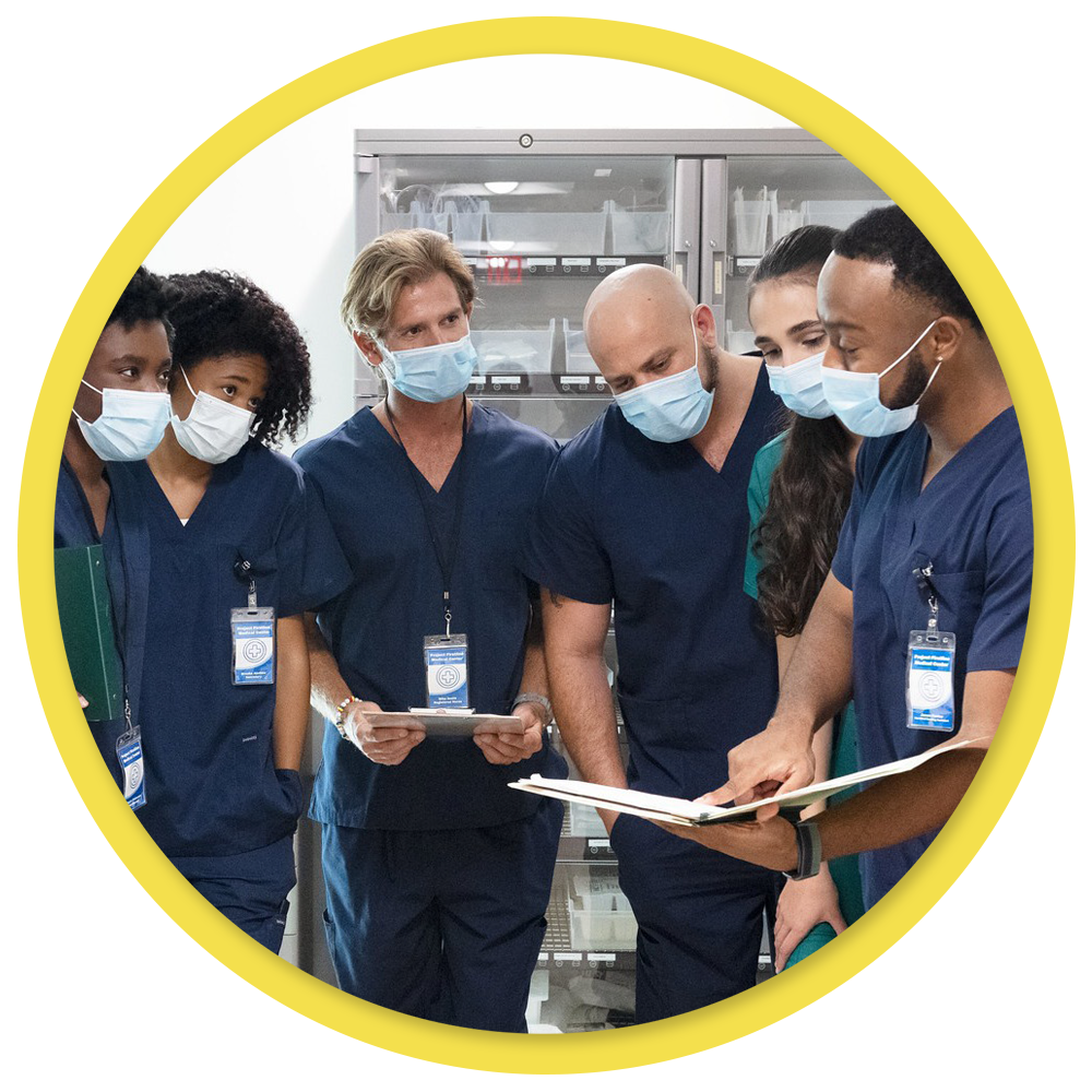 Group of healthcare staff looking at a procedure manual.