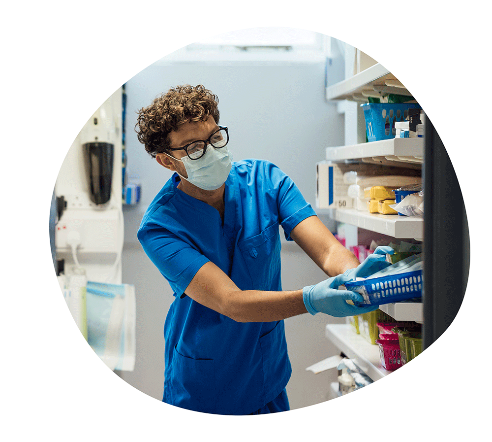 Nurse or dental assistant grabbing supplies from a medical supply area.
