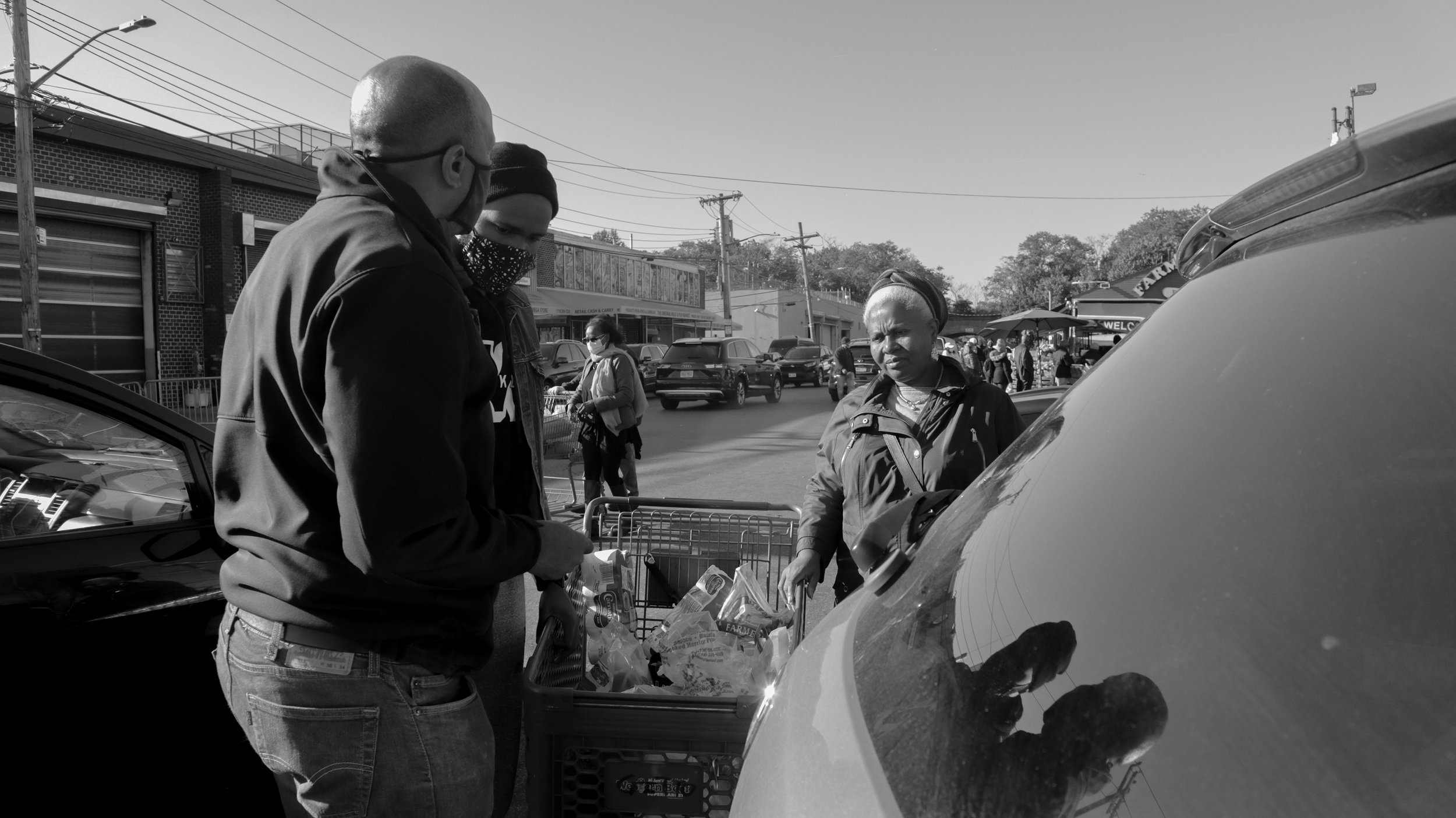 Jean, Alain (center), and Myrtho discuss how they will fill the barrel before heading home.