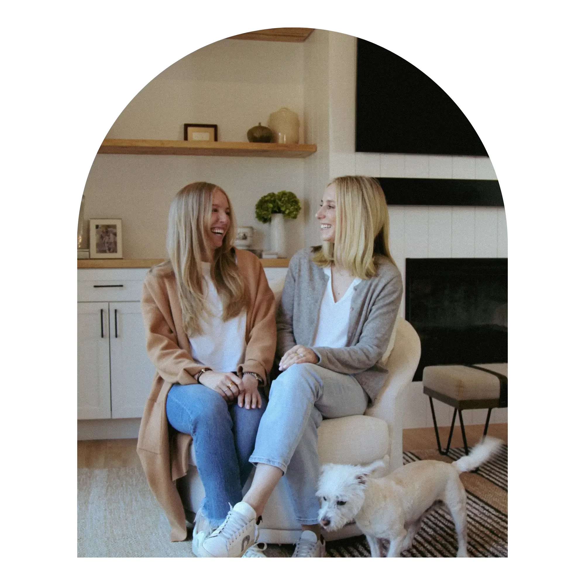 Lyle and Sally, the owners of bridge the gap services laughing on a couch.