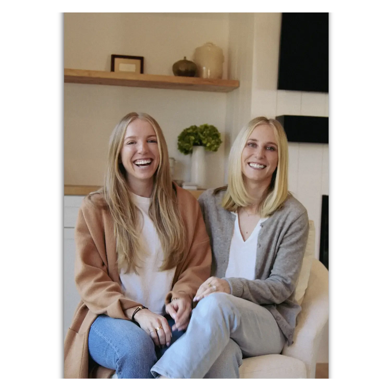 Lyle and Sally, the owners of bridge the gap services laughing on a couch.
