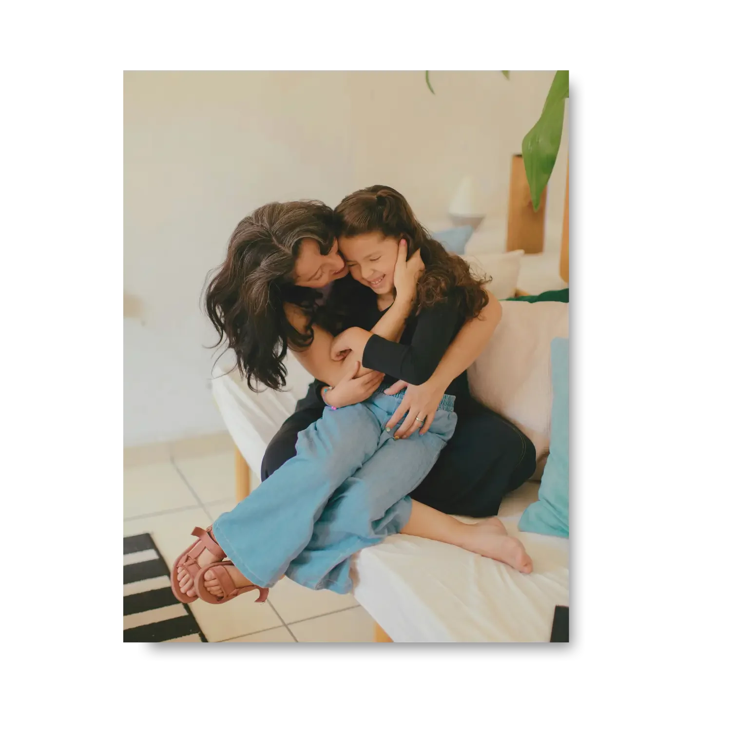 Mother showing affection and kissing daughter during family coaching session - Bridge The Gap