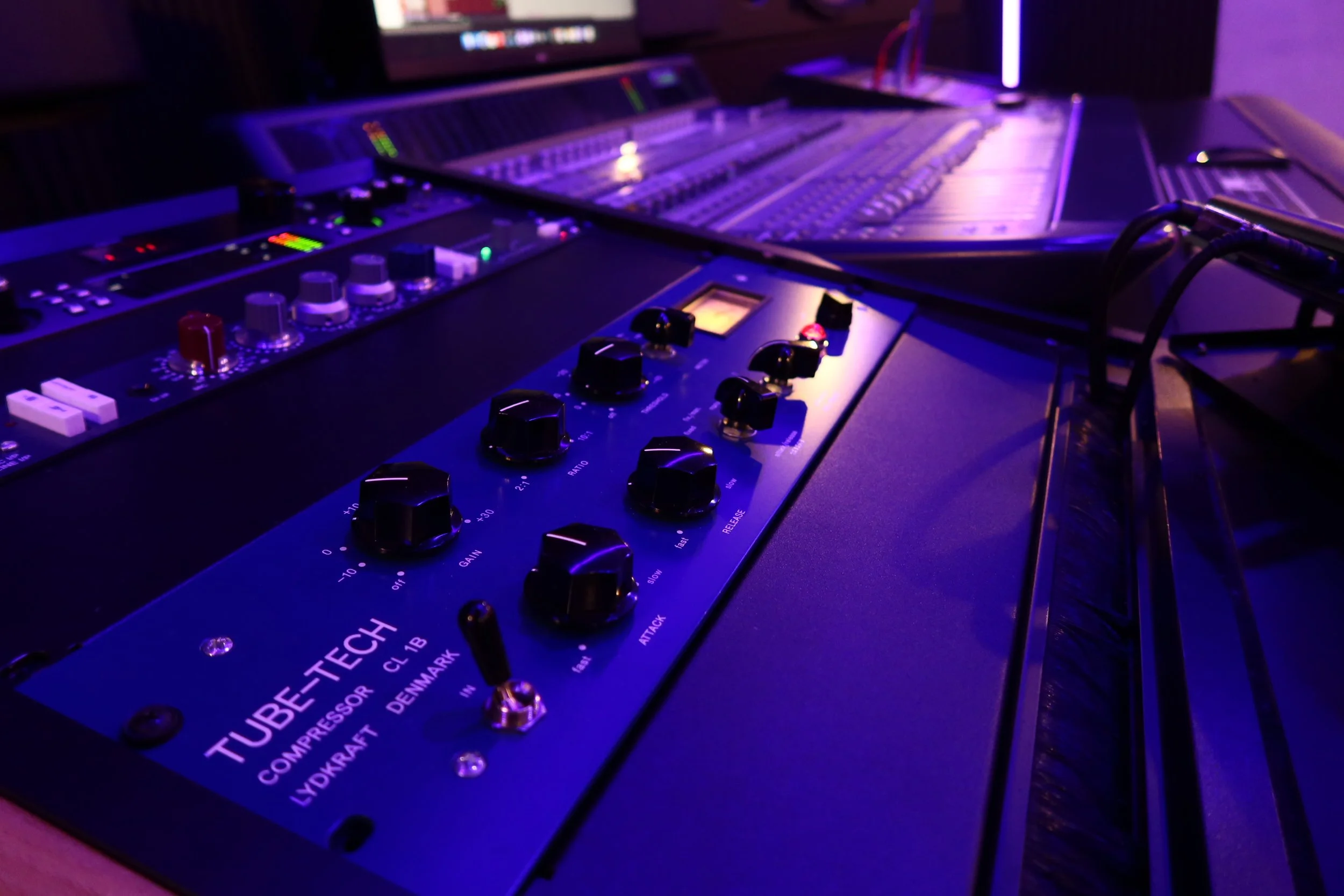 Audio mixing console and Tube-Tech compressor in a recording studio.