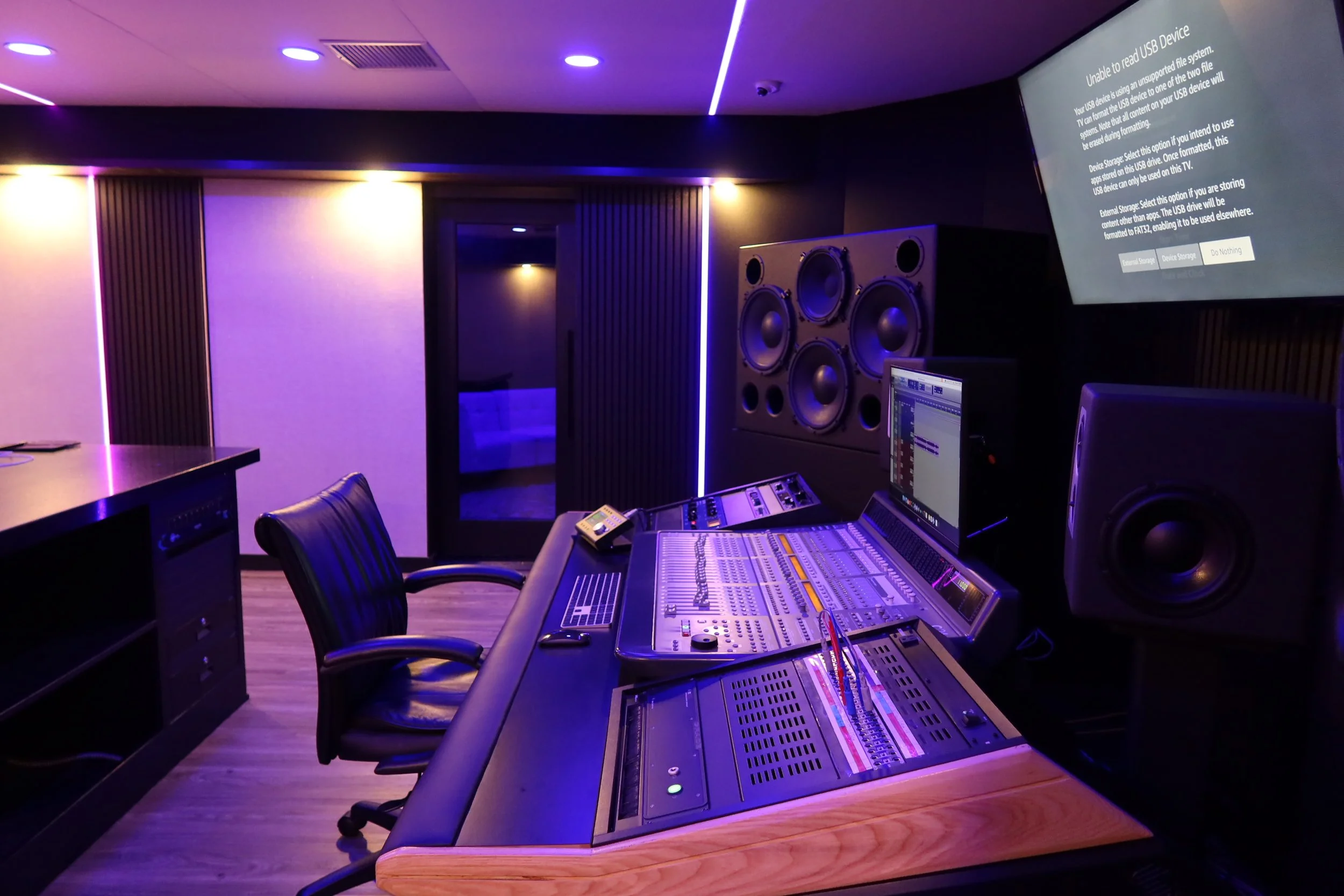 High-tech recording studio with mixing console, speakers, and monitors