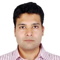 Portrait of a man wearing a striped shirt, looking directly at the camera with a neutral expression against a white background.