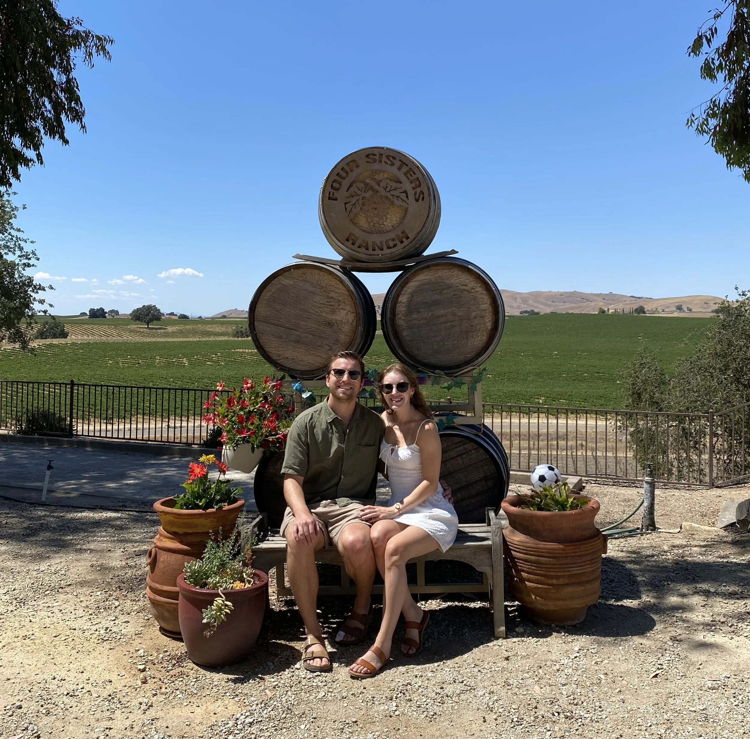 Engaged couple enjoying the vineyard view at Four Sisters Ranch Vineyards & Winery in Paso Robles wine country