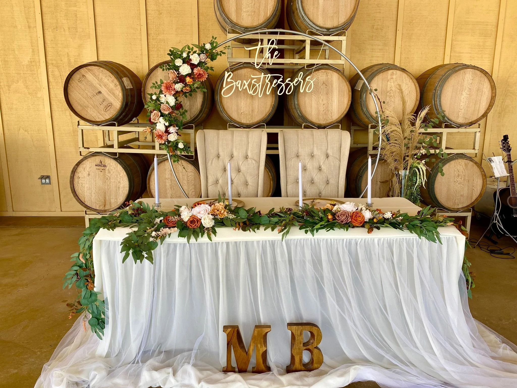 Wine barrel decor and sweetheart table at wedding - Four Sisters Ranch Vineyards & Winery wedding venue in Paso Robles wine country